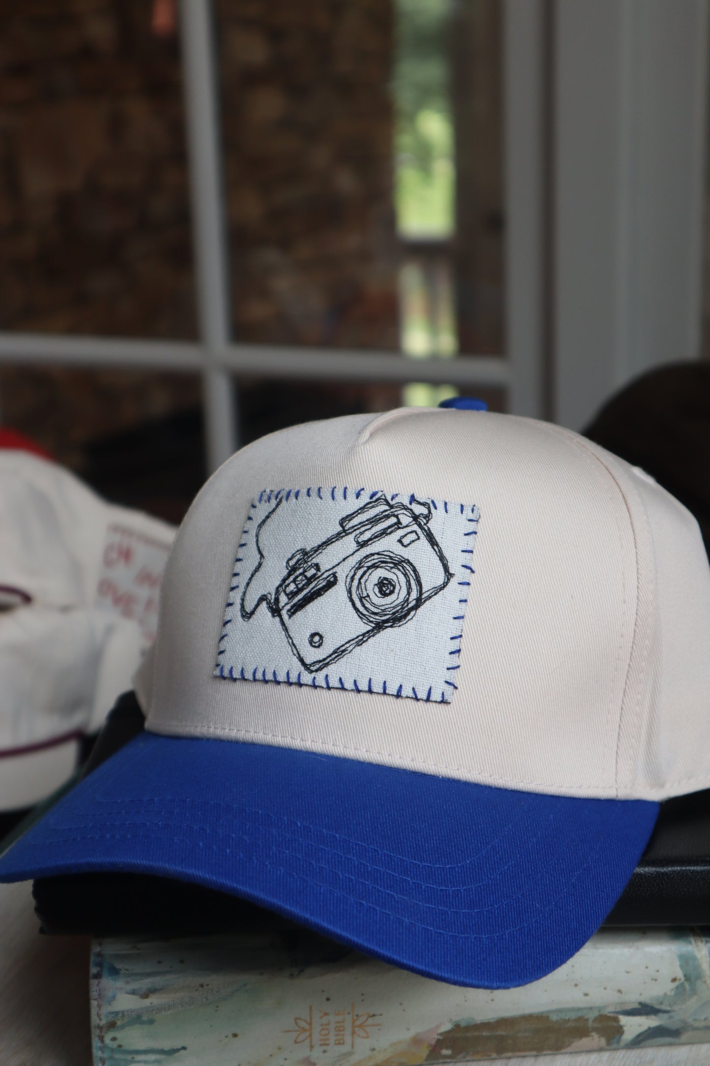 camera - blue trucker hat