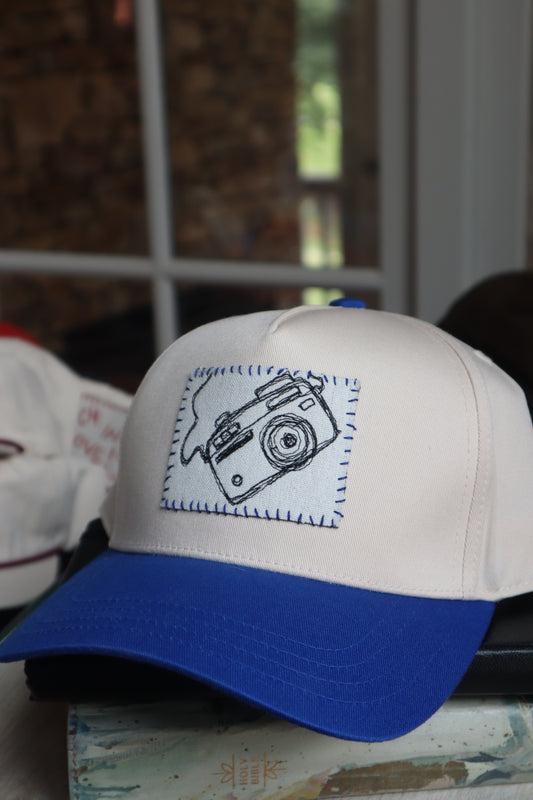 camera - blue trucker hat